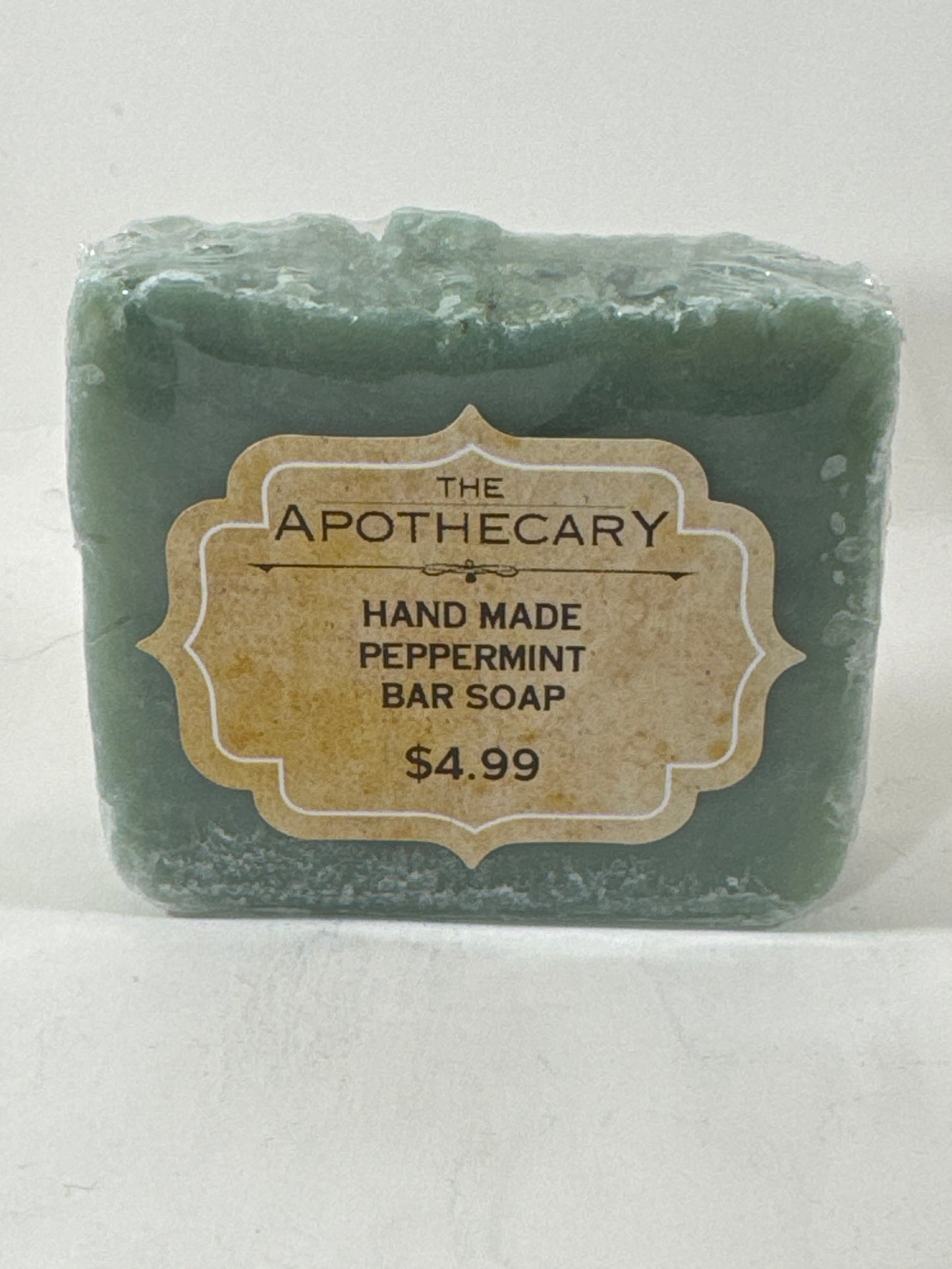 Green soap bar with a label on a white background